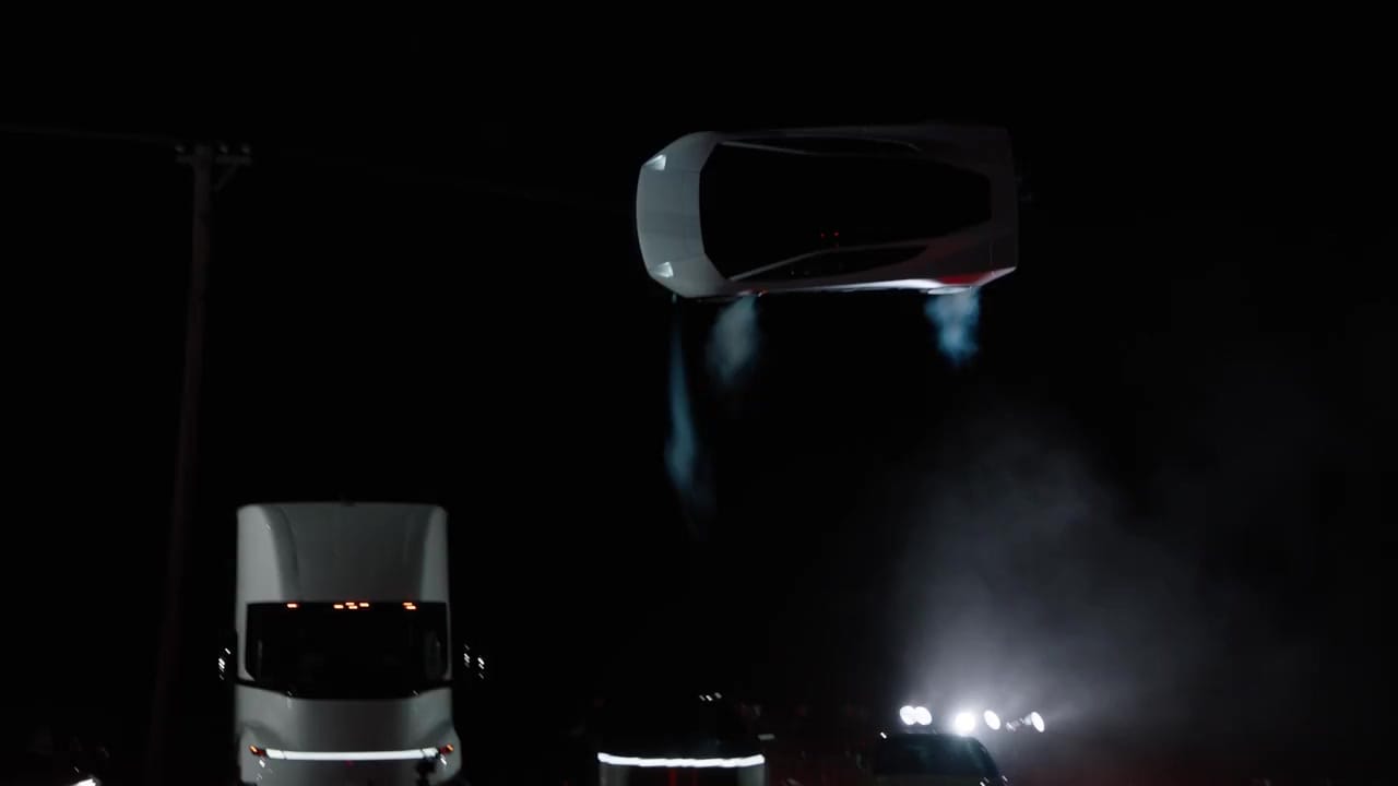 Tesla Roadster above the demonstration setup in a frame from its official kickflip video.