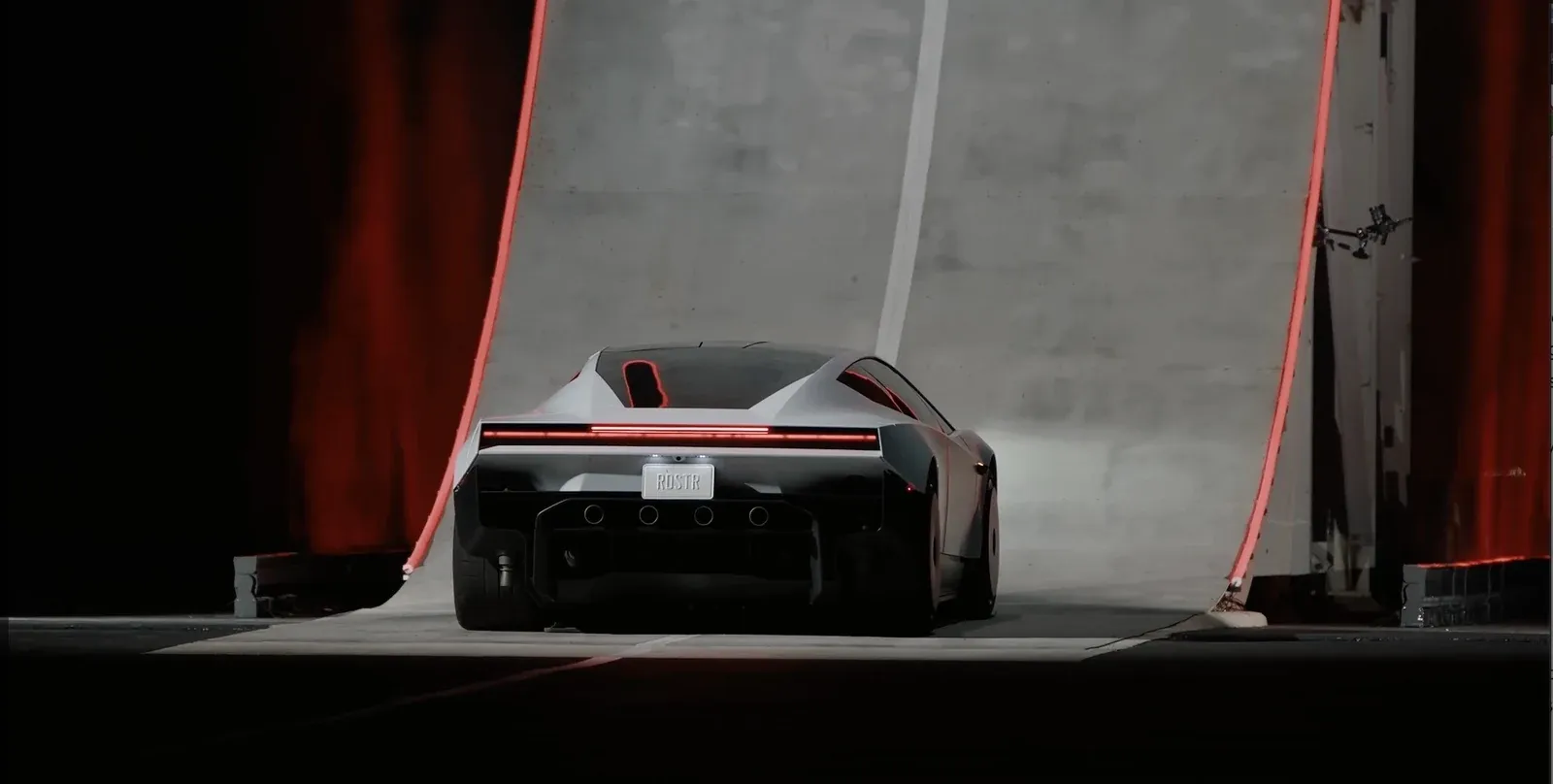 Rear view of the Tesla Roadster on the event reveal ramp, in an image credited to Tesla by TechCrunch.